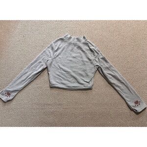 Medium light grey turtleneck with cat paws and a thumb hole.